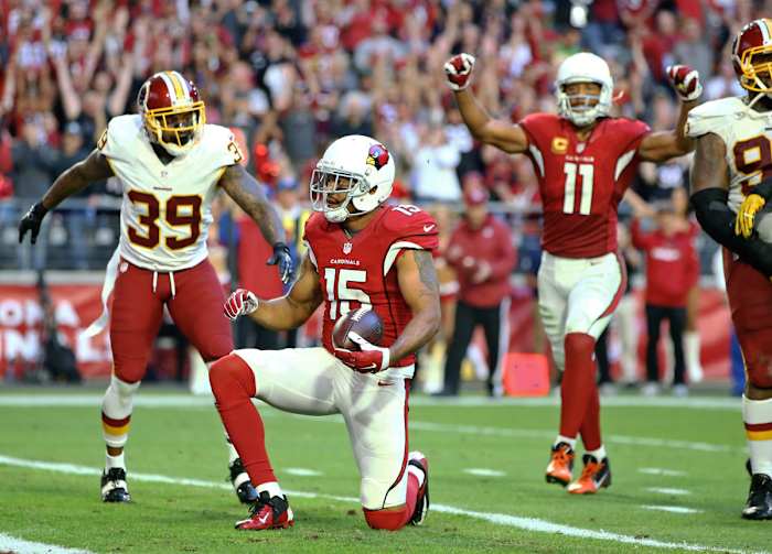 Arizona receivers Michael Floyd (15) and Larry Fitzgerald (11) celebrate after Floyd scored against Washington in 2016. Both are among the 13 players in Cardinals history to catch more than 1,000 receiving yards in a season.
